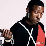 Ronnie Nyakale smiling while seated in a car, wearing casual clothing.