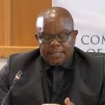 Here’s a **short, clean alt-text style version**: **Alt text:** *KZN Hawks head Maj Gen Lesetja Senona faces scrutiny at the Madlanga Commission after evidence emerged that he allegedly shared a confidential SAPS docket containing officers’ personal details with organised crime accused Vusimusi “Cat” Matlala.* If you want it **even tighter** (social preview / image caption length), I can trim it further.